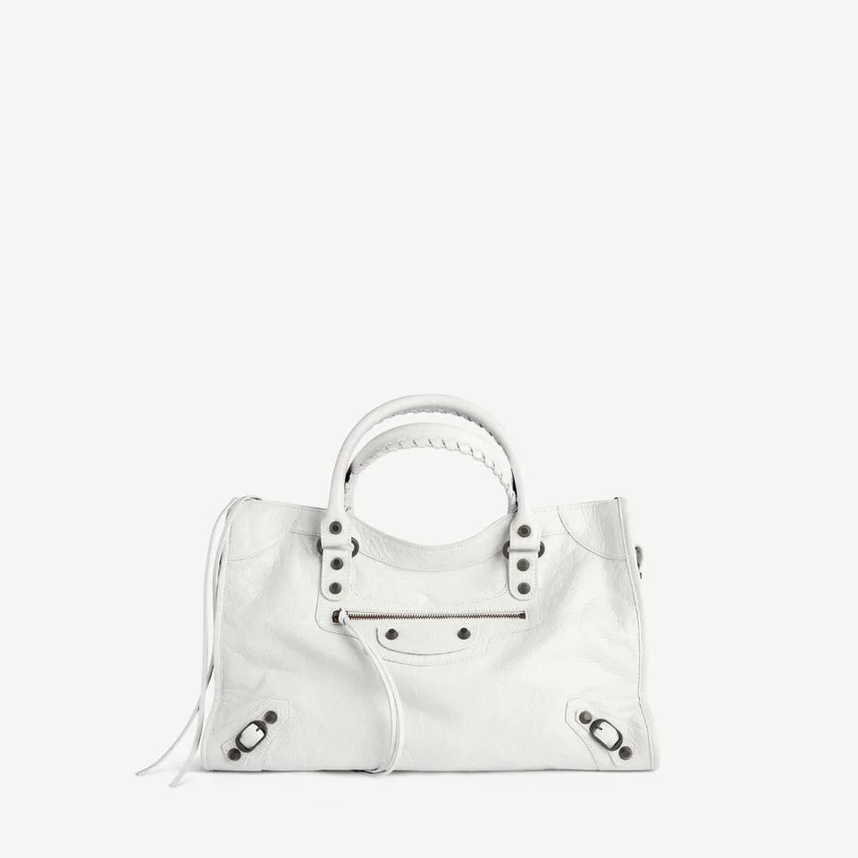 Contemporary Balenciaga Le City Medium in optic white, with leather ties, front zip and studded corners.