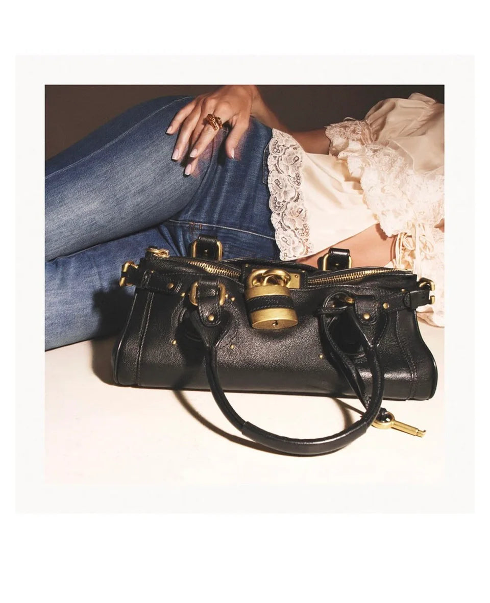 Black Paddington bag styled with lace and denim inside a printed border.
