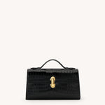 Black handbag with a gold clasp on a white background