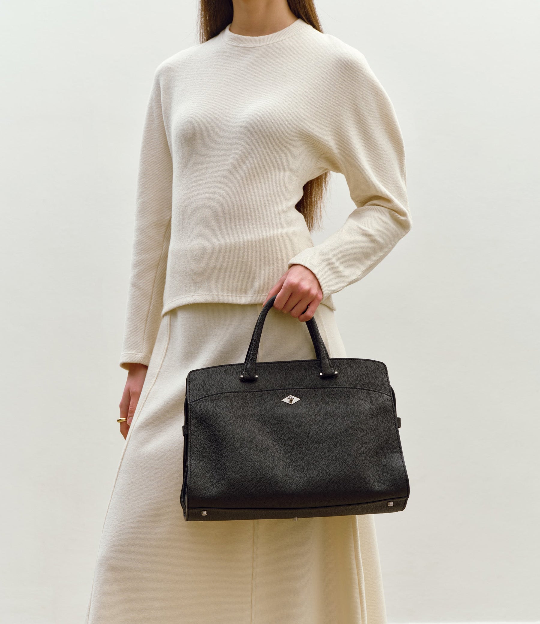 Black Métier Private Eye bag shown in a real day-to-evening setting