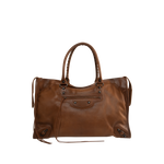 Image 1 of 3 - BROWN - Balenciaga Men's Le City Bag Large is crafted from vintage goatskin and features the house's iconic relaxed silhouette with two hand-braided handles detailed with waxed cord. Designed for hand or crossbody carry, this designer bag features an adjustable and removable shoulder strap with shoulder pad, brass hardware, a double-sided zip closure with long tails and knotted leather puller, front zipped pocket, interior zipped pocket, removable mirror with tone-on-tone Balenciaga logo, and