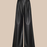 The Chelsy Leather Wide-Leg Pant is a high-waisted, wide-leg black leather pair displayed against a plain beige background. These pants feature a smooth texture and subtle seam detailing at the knee area.