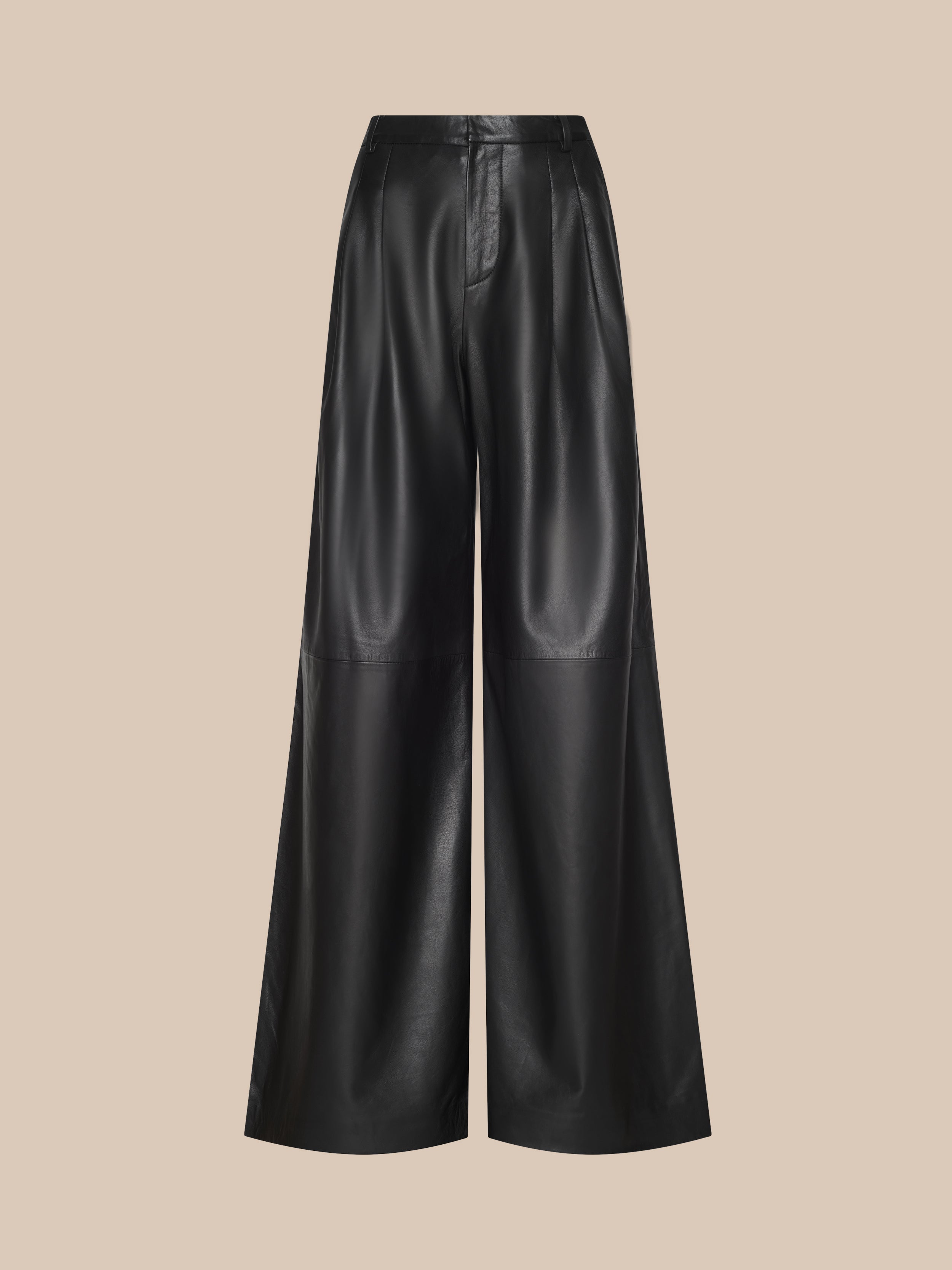 The Chelsy Leather Wide-Leg Pant is a high-waisted, wide-leg black leather pair displayed against a plain beige background. These pants feature a smooth texture and subtle seam detailing at the knee area.