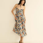 Woman wearing a floral dress on a beige background