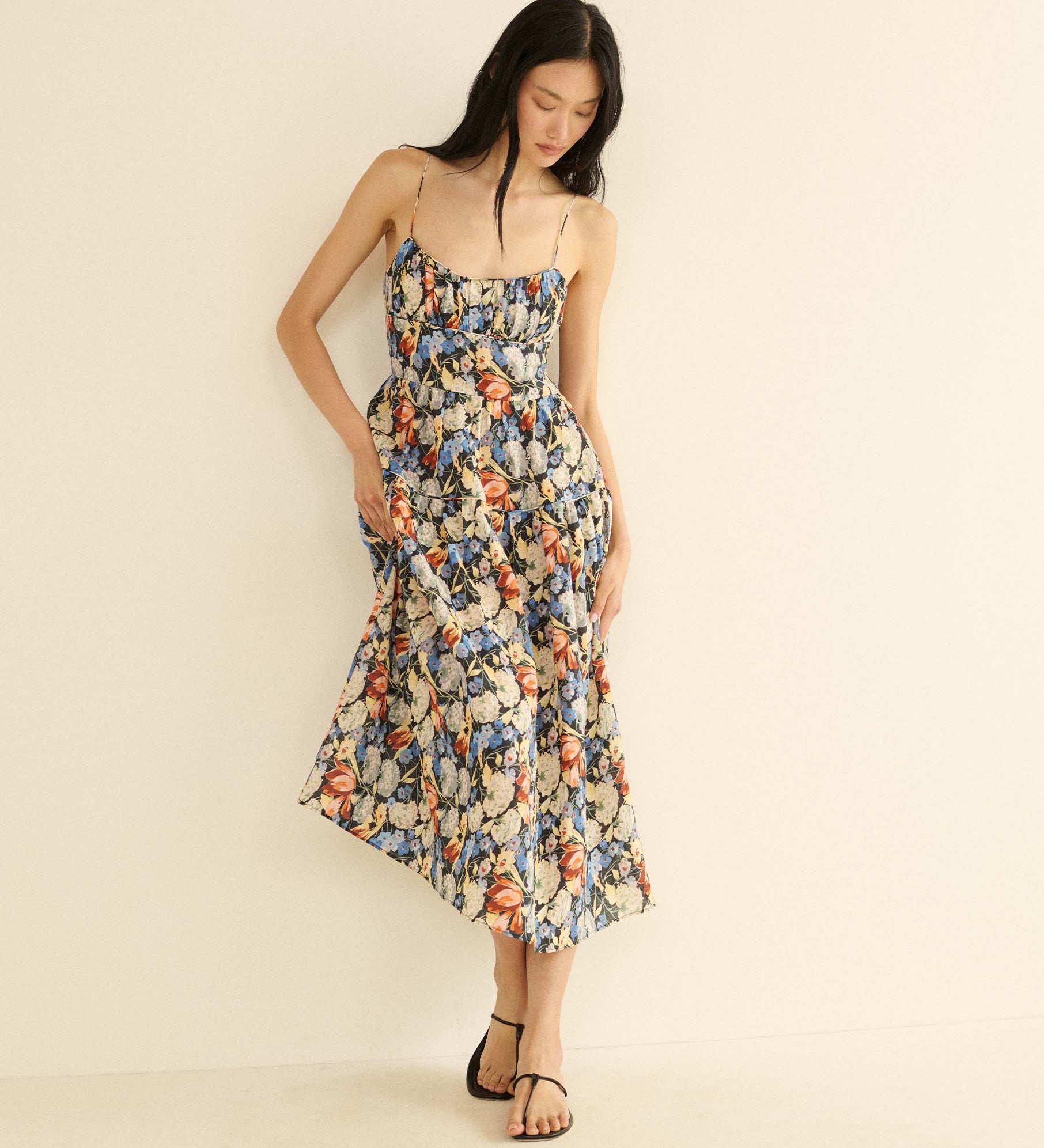 Woman wearing a floral dress on a beige background