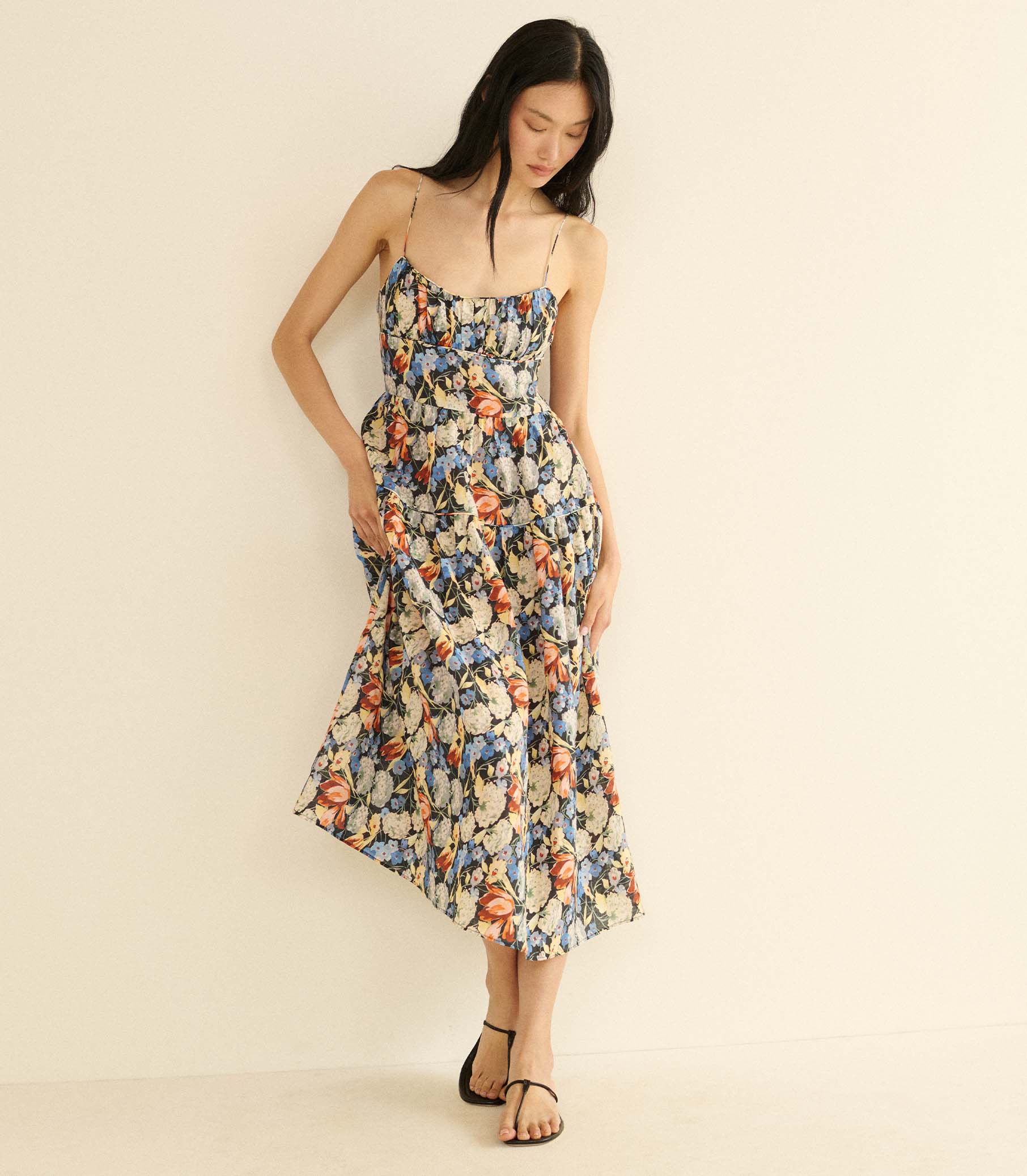 Woman wearing a floral dress on a beige background