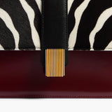 Khaite - Blake Crossbody Bag in Zebra Haircalf and Oxblood Leather