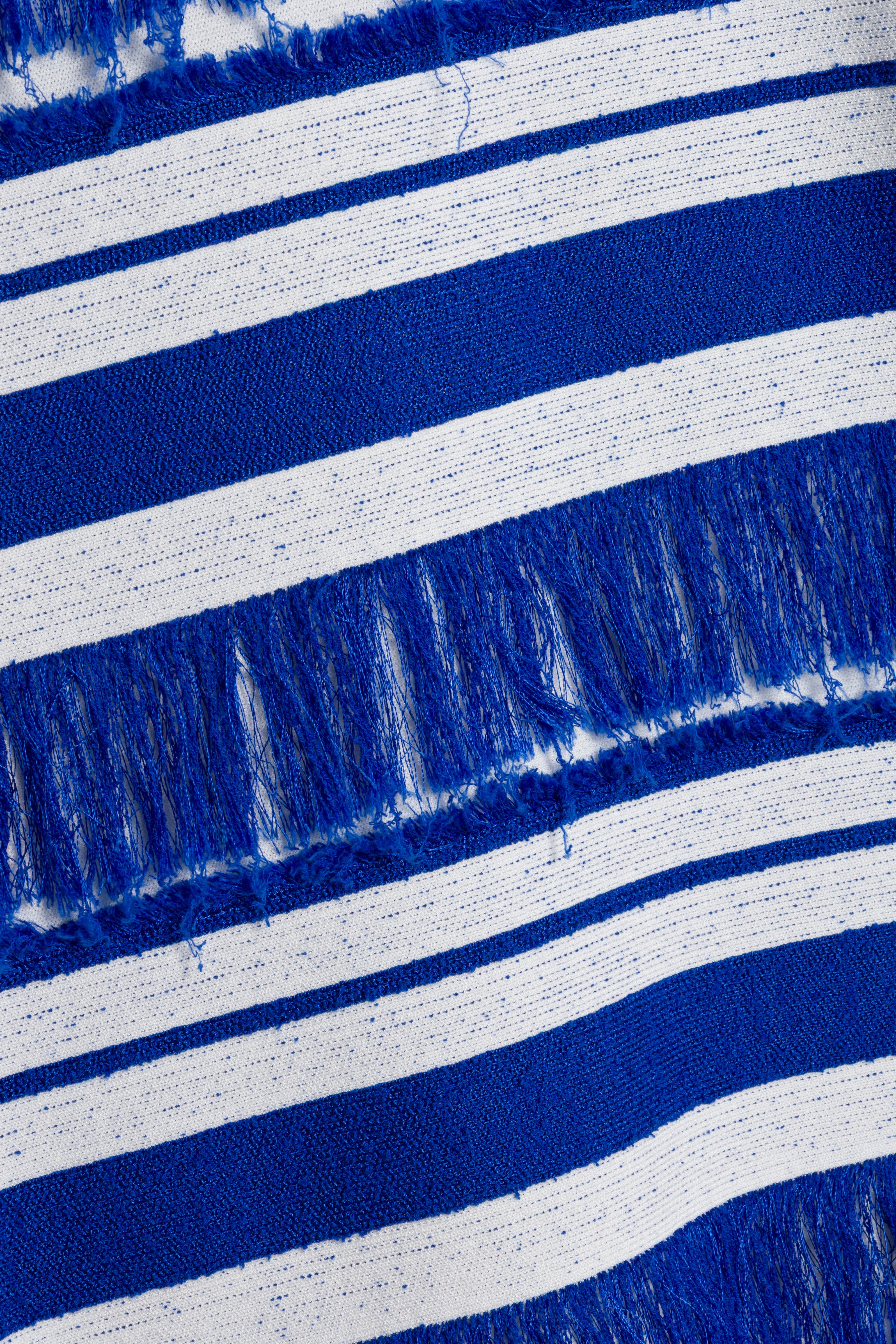 Blue and white horizontal striped knit fabric with fringe trim detail.