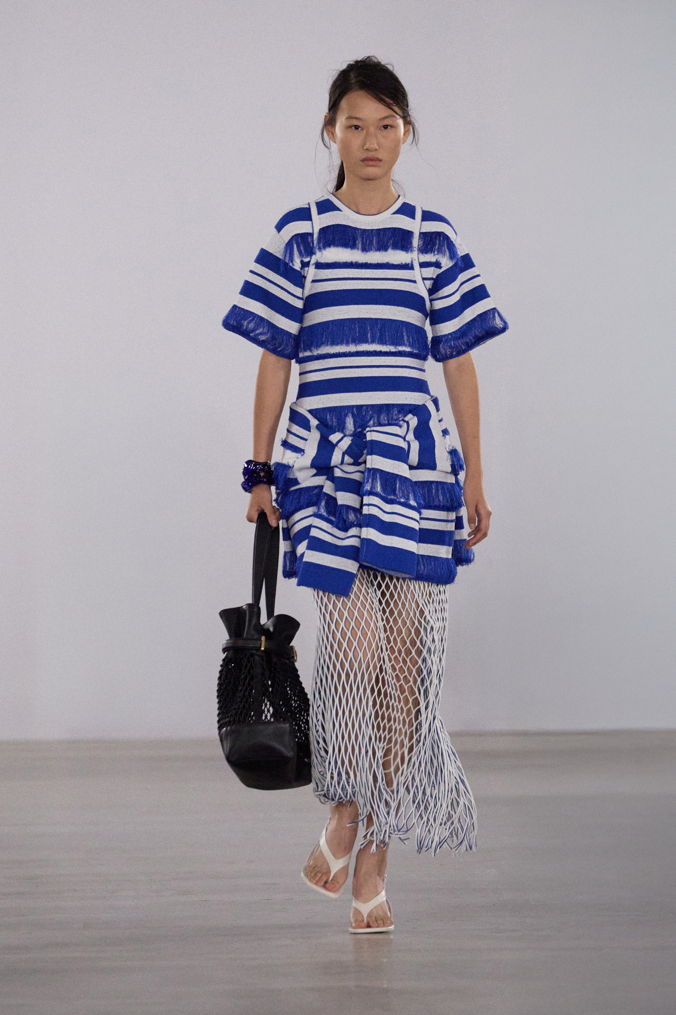 Blue and white striped knit mini dress with textured short sleeves and fringed hem detail.