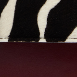 Khaite - Blake Crossbody Bag in Zebra Haircalf and Oxblood Leather