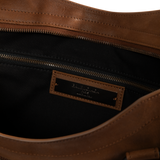 Image 3 of 3 - BROWN - Balenciaga Men's Le City Bag Large is crafted from vintage goatskin and features the house's iconic relaxed silhouette with two hand-braided handles detailed with waxed cord. Designed for hand or crossbody carry, this designer bag features an adjustable and removable shoulder strap with shoulder pad, brass hardware, a double-sided zip closure with long tails and knotted leather puller, front zipped pocket, interior zipped pocket, removable mirror with tone-on-tone Balenciaga logo, and