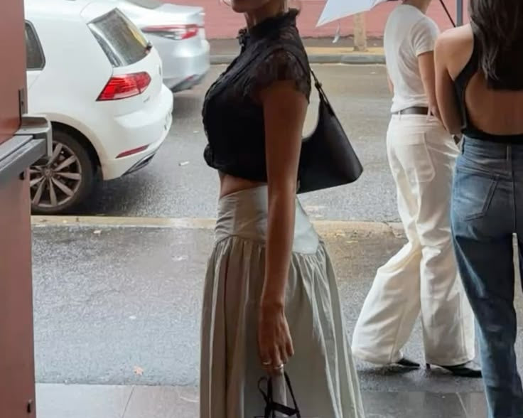 stylish woman standing on the street in cute outfit
