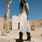 Goldy Espresso Woven Leather Tall Boot in espresso woven leather, Wynn Cardigan in grey wool, and Tinsley Skirt in white cotton.