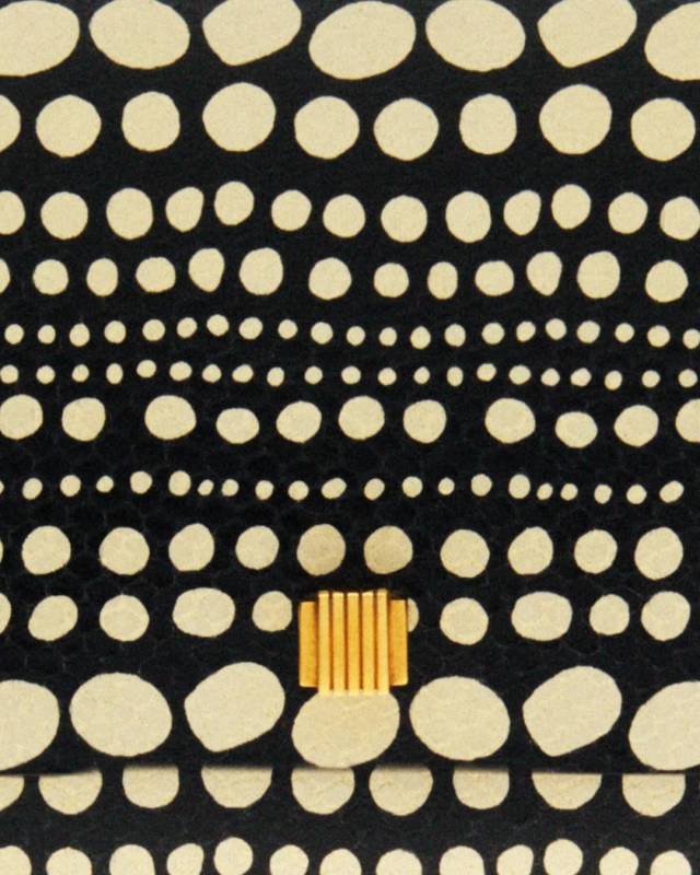 Patterned fabric with beige dots on a black background