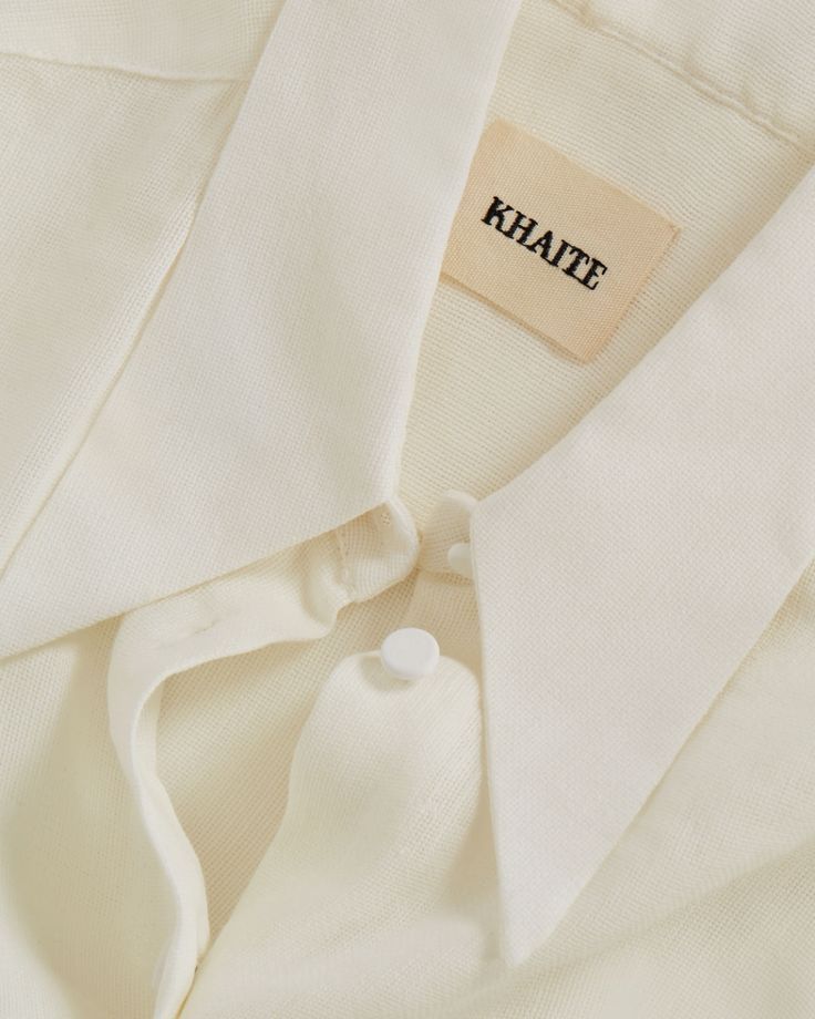 Close-up of a cream-colored garment with a 'Khaite' label.