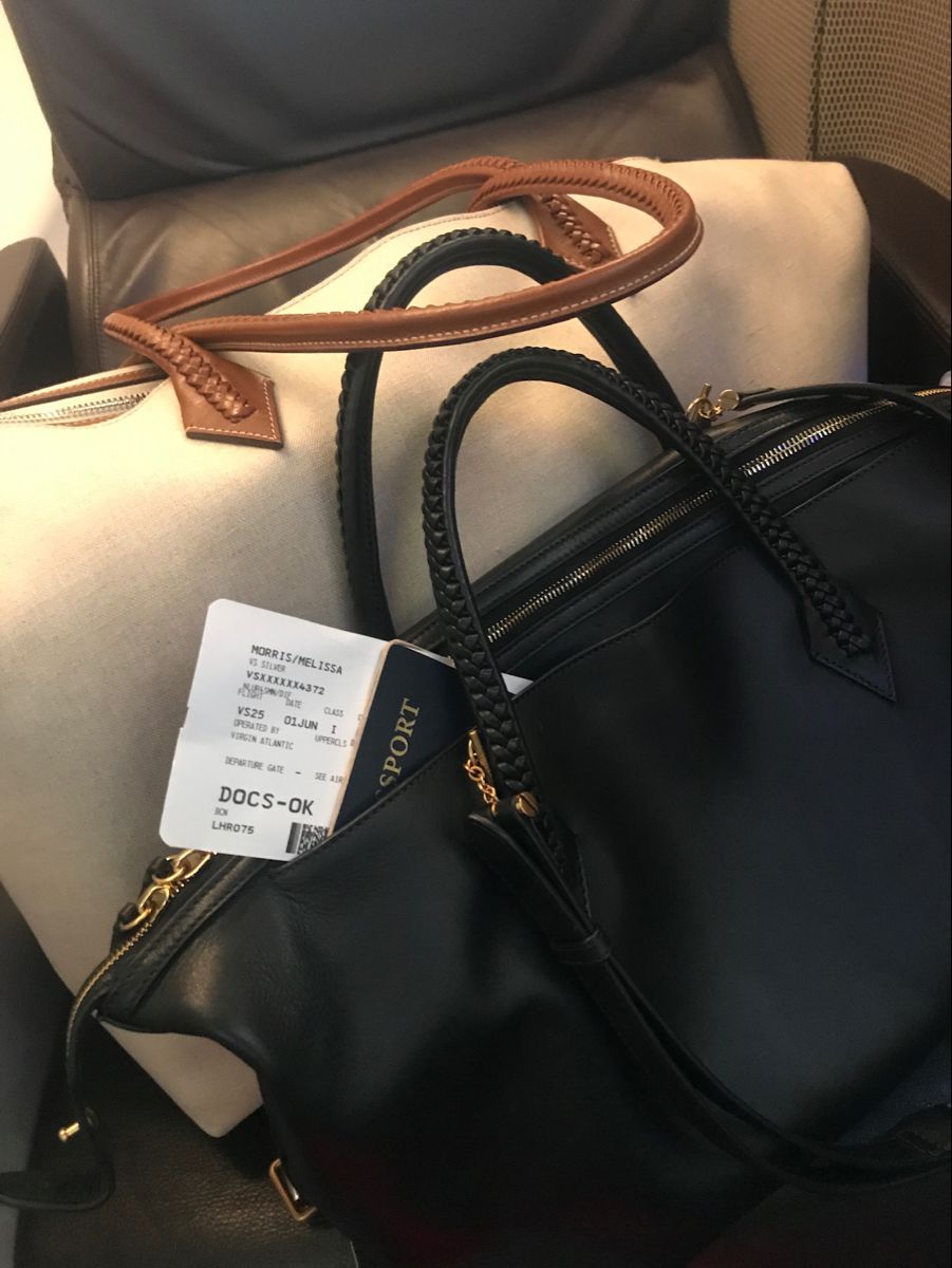 Black handbag with a visible tag on a seat
