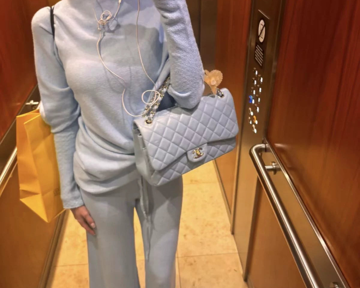 stylish woman in ton sir ton luxury outfit making an elevator selfie