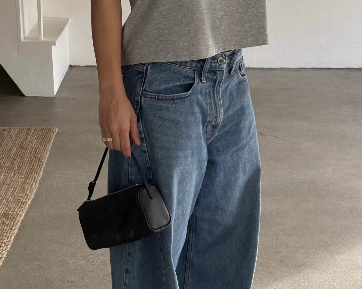 stylish woman in jeans and t-shirt minimal luxury outfit