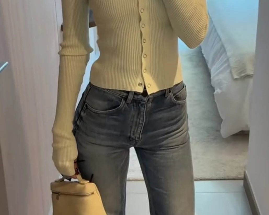woman making a mirror selfie of her minimal luxury outfit
