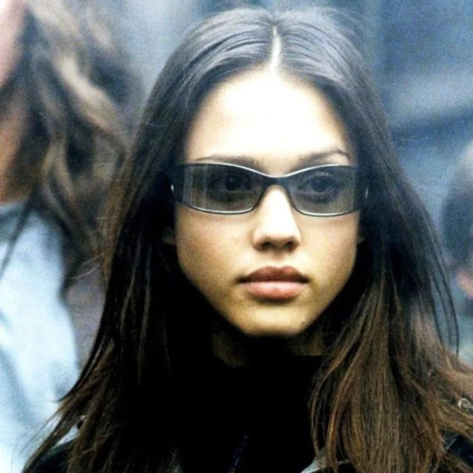 Woman wearing narrow sunglasses and a pale roll-neck top.